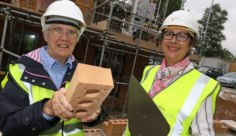 Carol Sangster left and Cllr Gail Harris lay the Golden Brick at Leander Court in Norwich 1