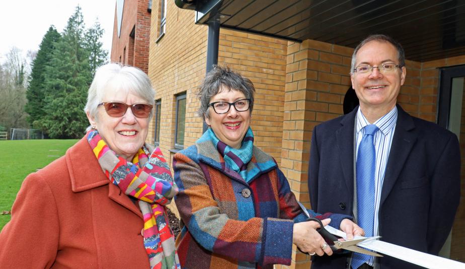 Cllr Gail Harris cuts the ribbon at Leander Court watched by Norwich Housing Society chairman Carol Sangster and chief executive Mike Allen web