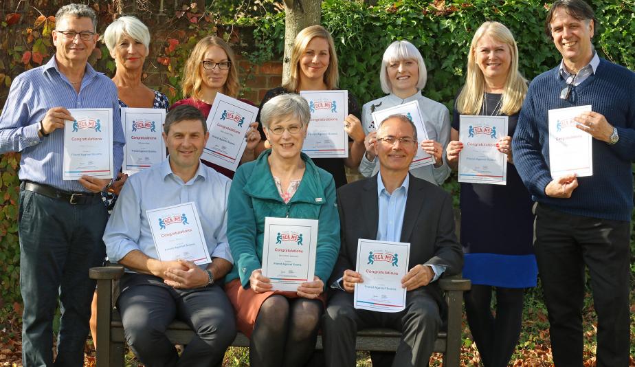 Staff at Norwich Housing Society with their Friends Against Scams certificates