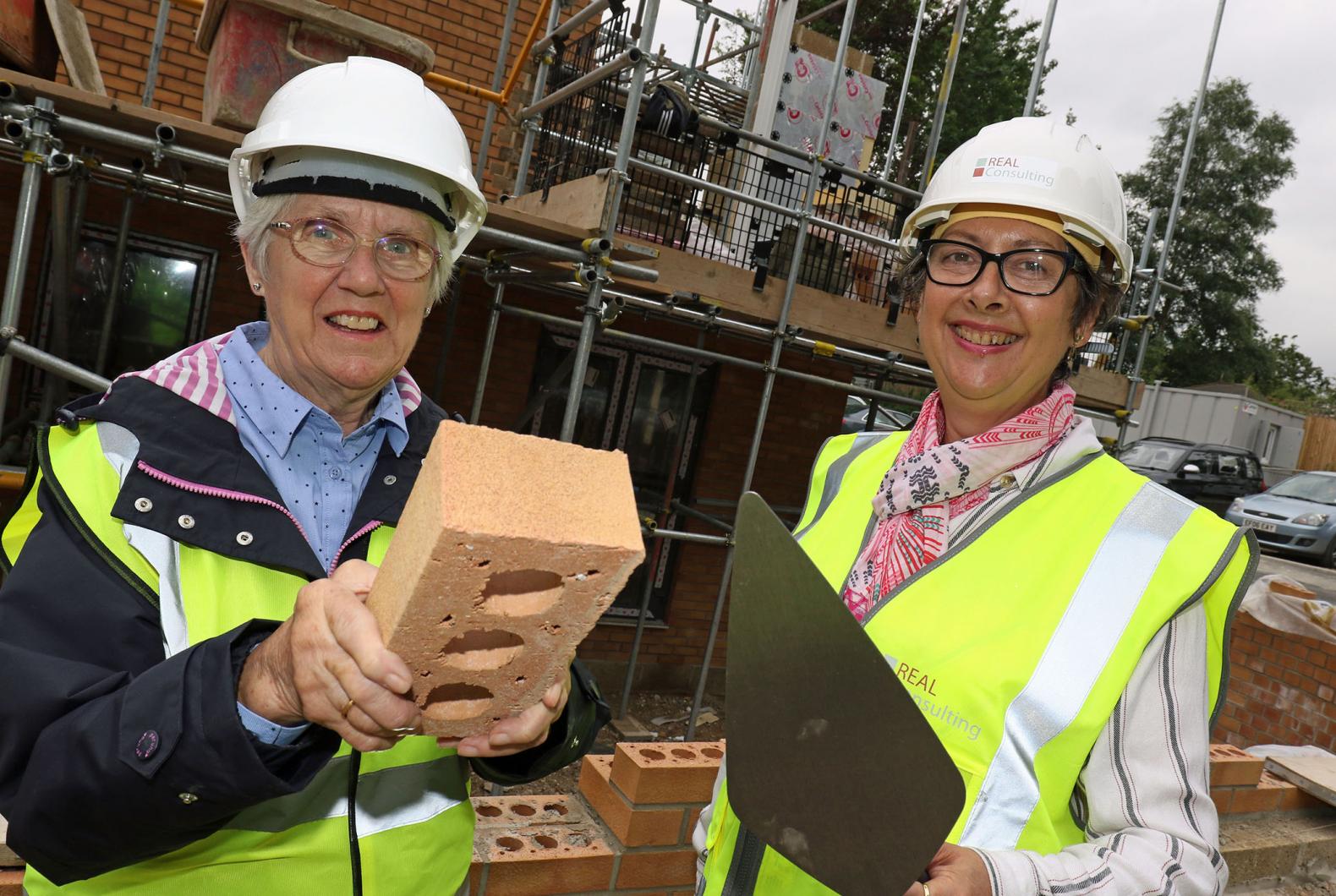 Carol Sangster left and Cllr Gail Harris lay the Golden Brick at Leander Court in Norwich 1