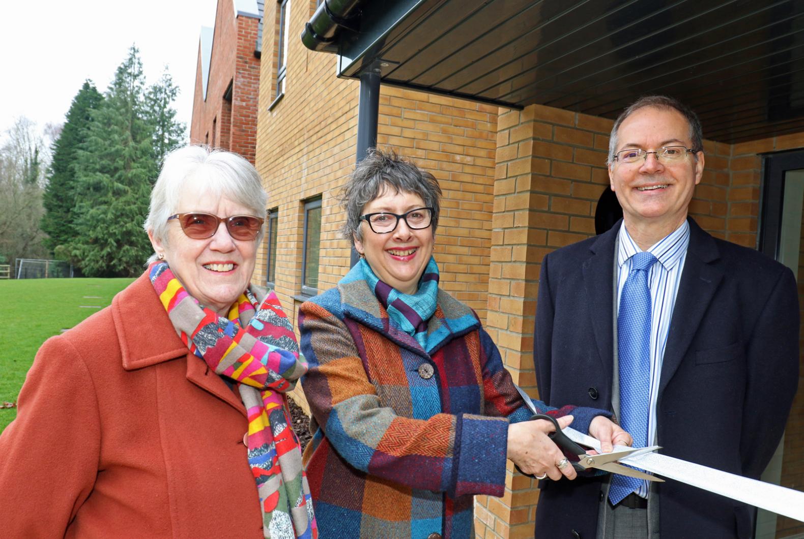 Cllr Gail Harris cuts the ribbon at Leander Court watched by Norwich Housing Society chairman Carol Sangster and chief executive Mike Allen web